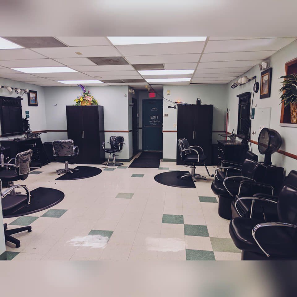 A salon with a lot of chairs and a fan