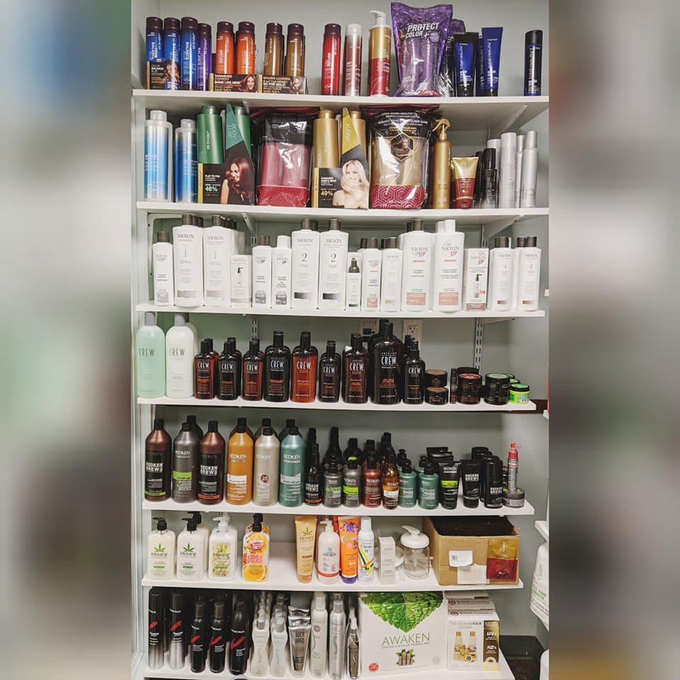 A shelf filled with lots of hair products including shampoo and conditioner.