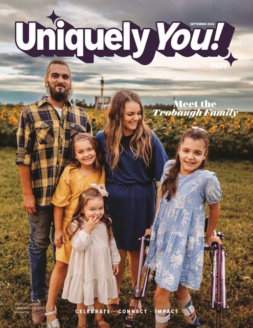 A family is standing in a field on the cover of a magazine.