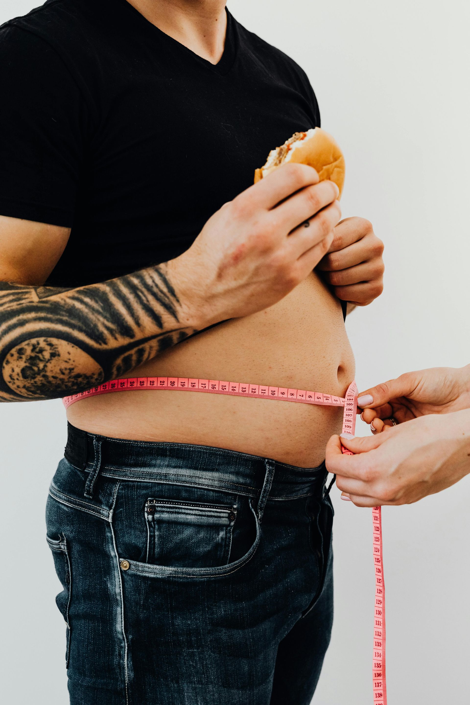 measuring the waistline of a man for weight management programme by a nutritionist in Coventry