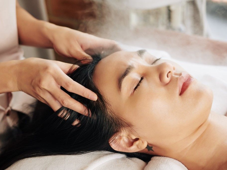 The Skinutrition Clinic performing a relaxing head massage as part of massage therapy spa day
