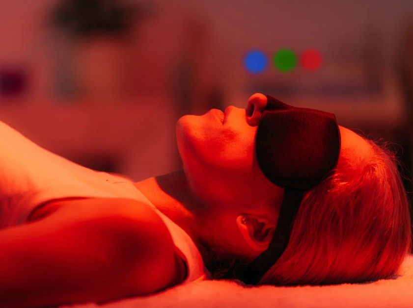 red light therapy panel illuminated on a client in the treatment room at a Coventry clinic