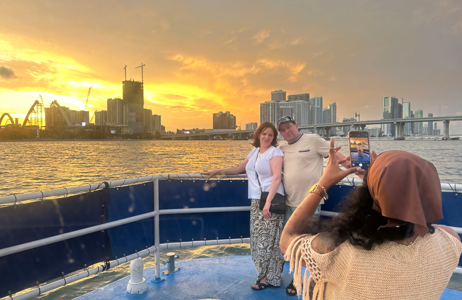 Miami Sunset cruise passengers taking photos with the Sunset in Miami in the Background