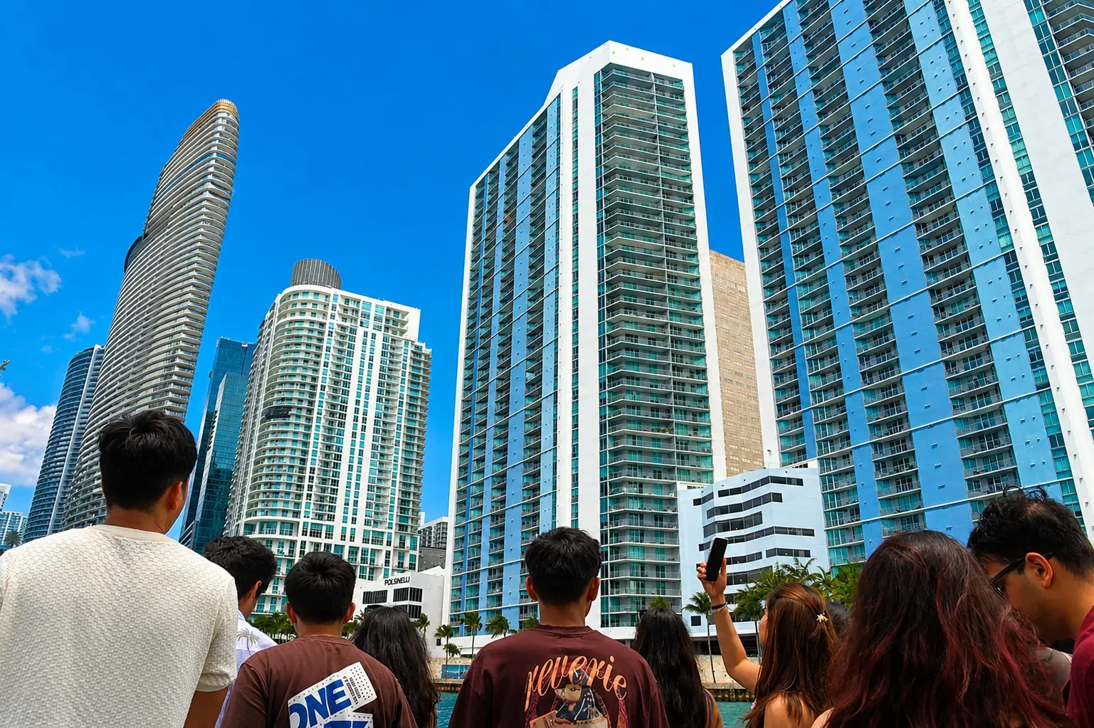 Visitors admiring the Aston Martin Residences and surrounding high-rise towers along the Miami skyline from Biscayne Bay