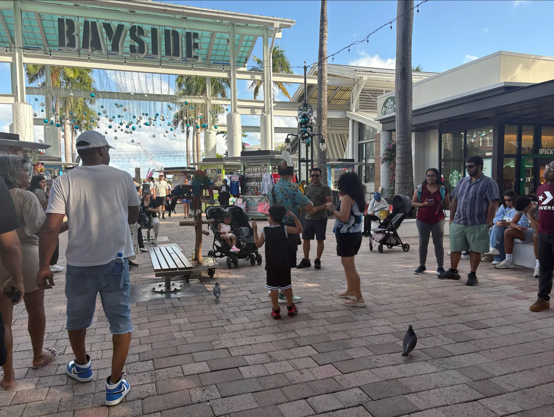Visitors walking, shopping and enjoying attractions at Bayside Marketplace in Miami.