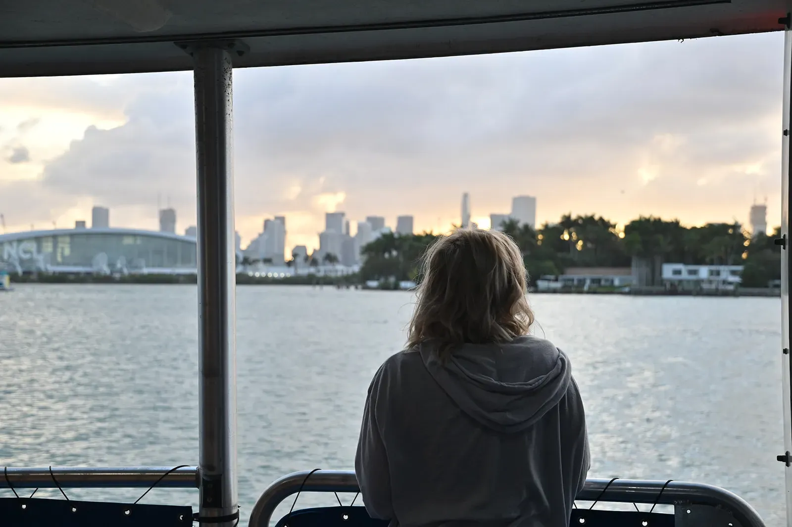Guest enjoying a sunset Miami boat tour with peaceful skyline views