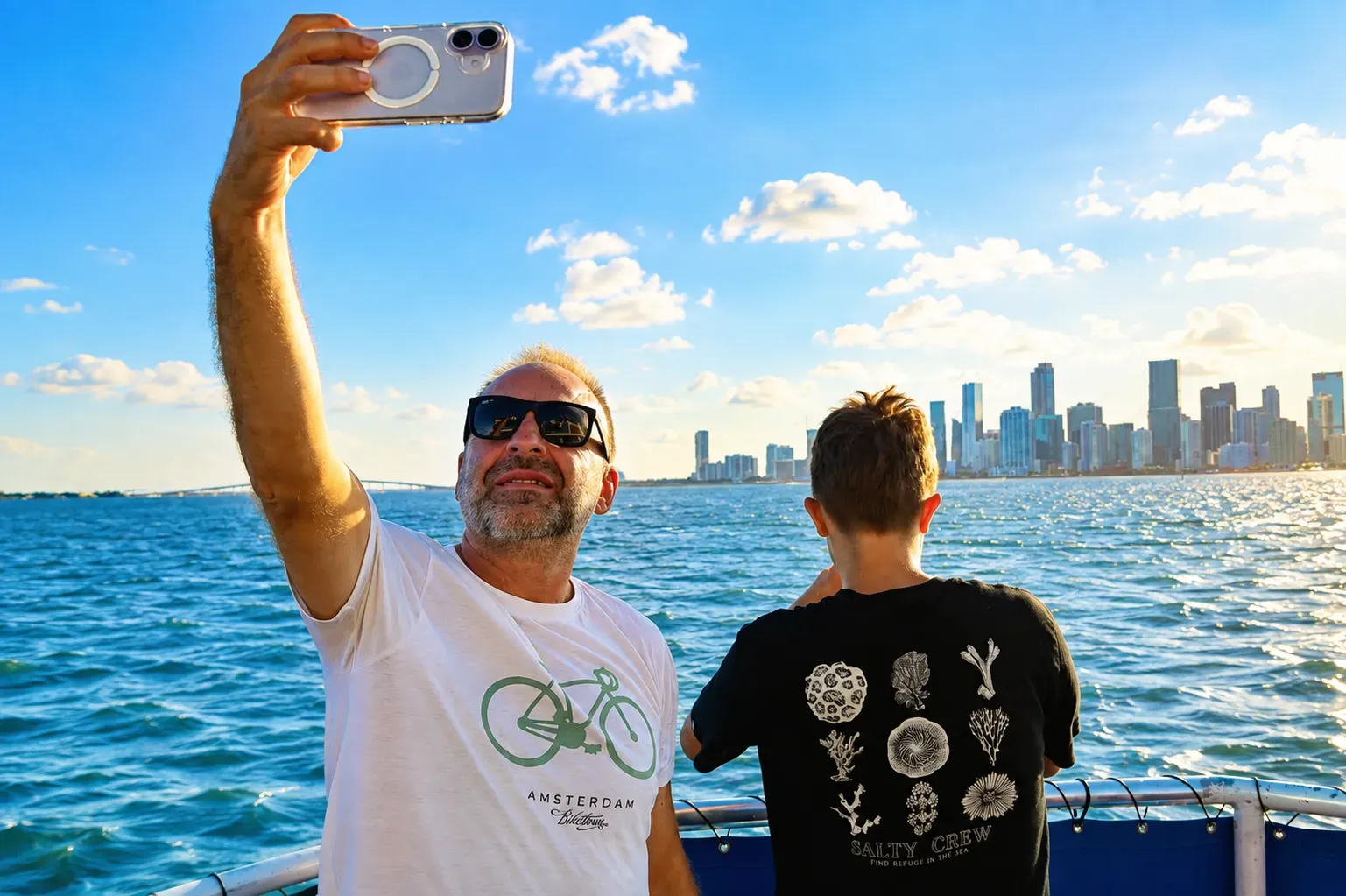 Guest taking a selfie during a discounted morning sightseeing cruise in Miami with the skyline across Biscayne Bay.