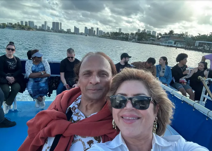 Guests enjoying a Miami Boat Tour on Biscayne Bay with the Miami skyline in the background