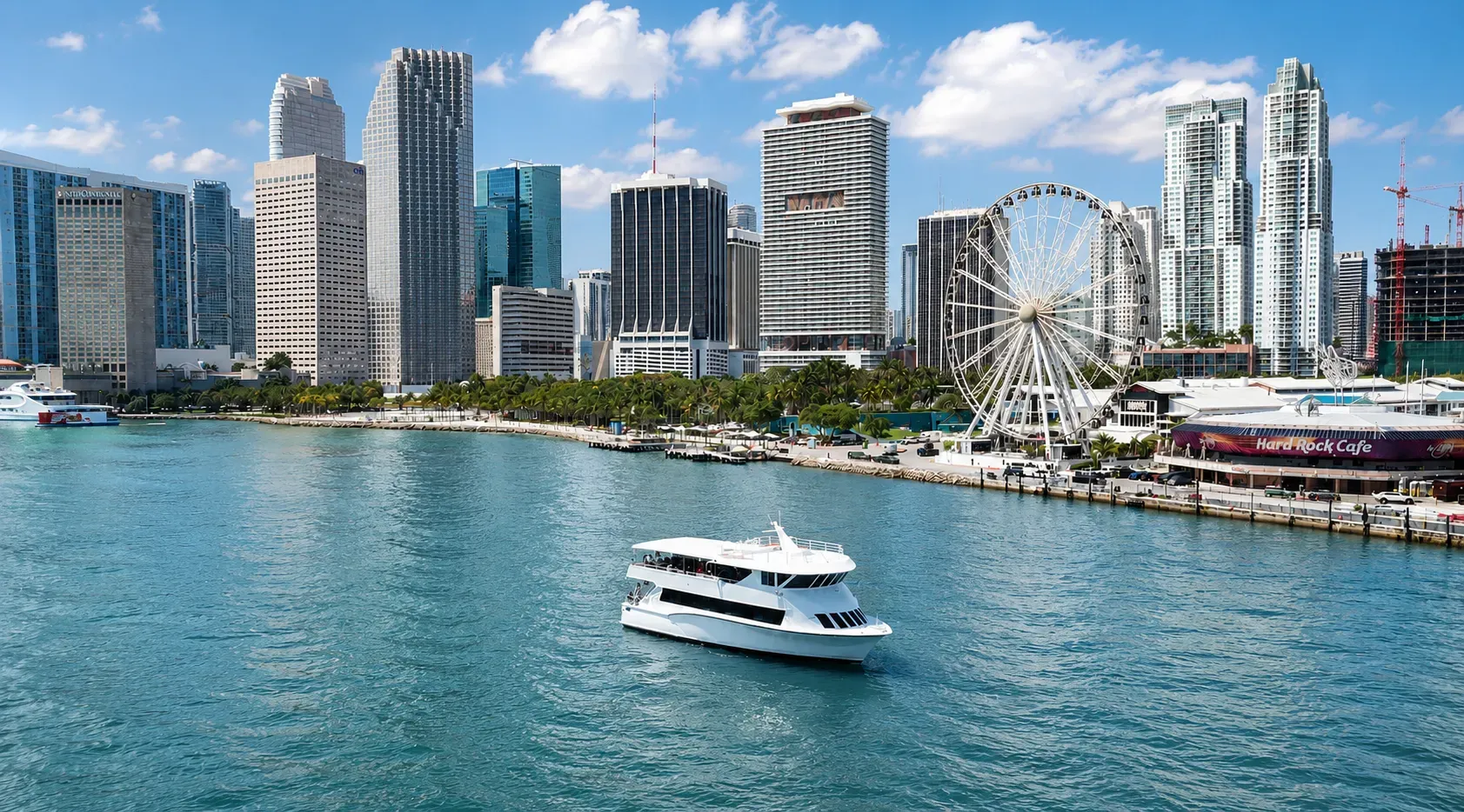 Miami boat tourism on Biscayne Bay with a sightseeing cruise near Bayside Marketplace and the Downtown Miami skyline.