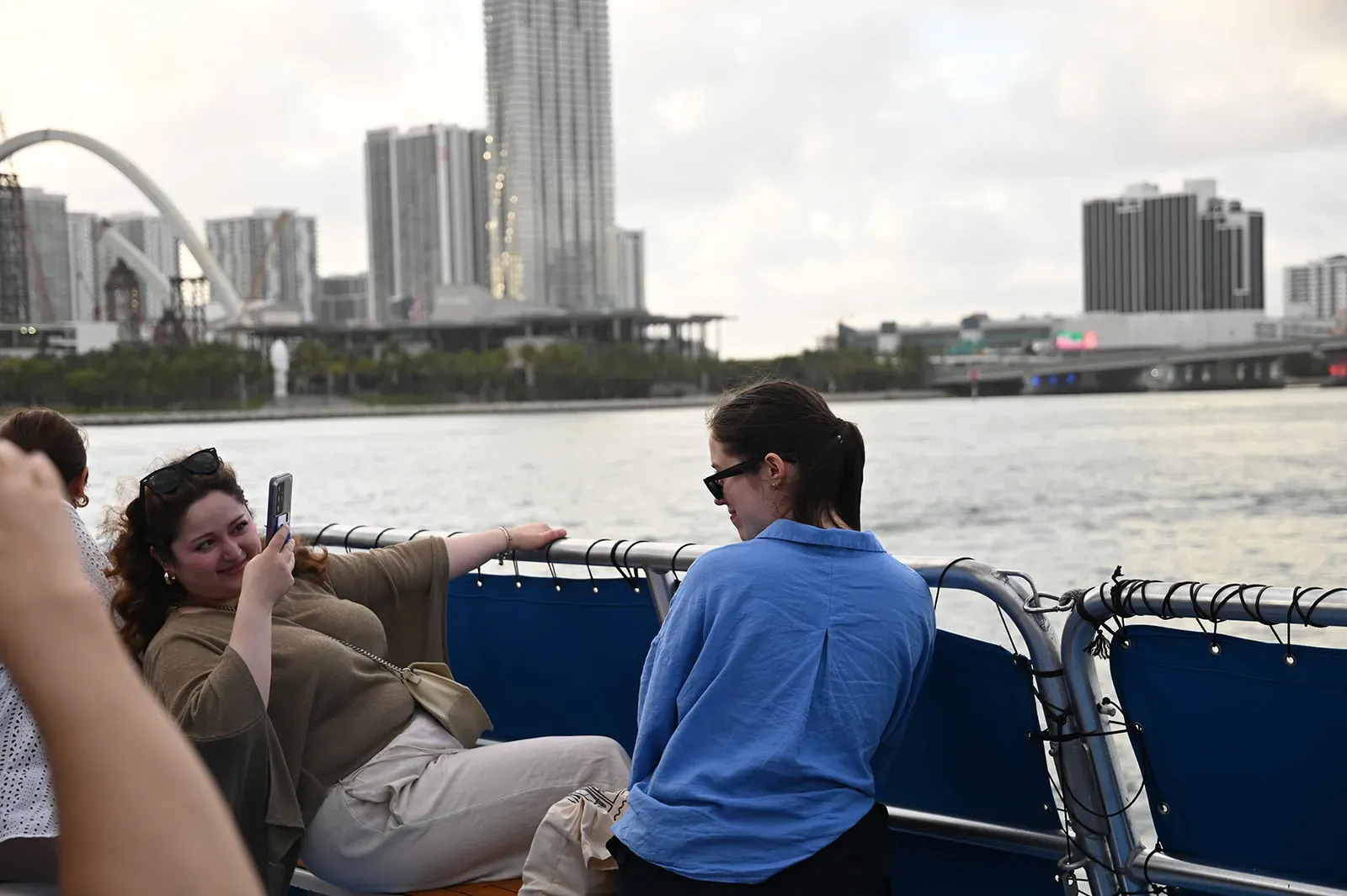 Guests on a Miami boat tour taking photos with the Miami skyline in the background
