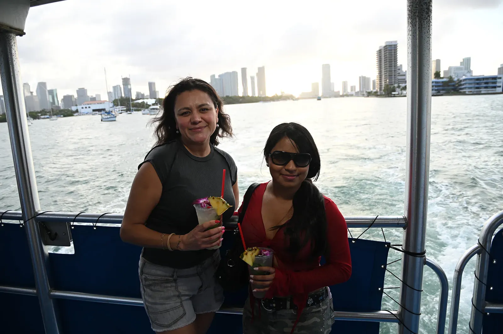 Guests enjoying drinks during a Miami sunset boat tour with skyline views
