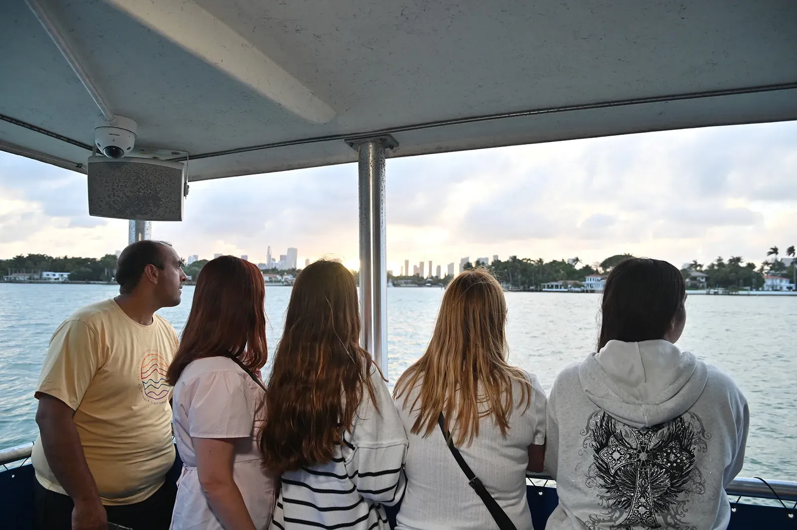 Guests enjoying a Miami sunset boat tour with skyline views over Biscayne Bay