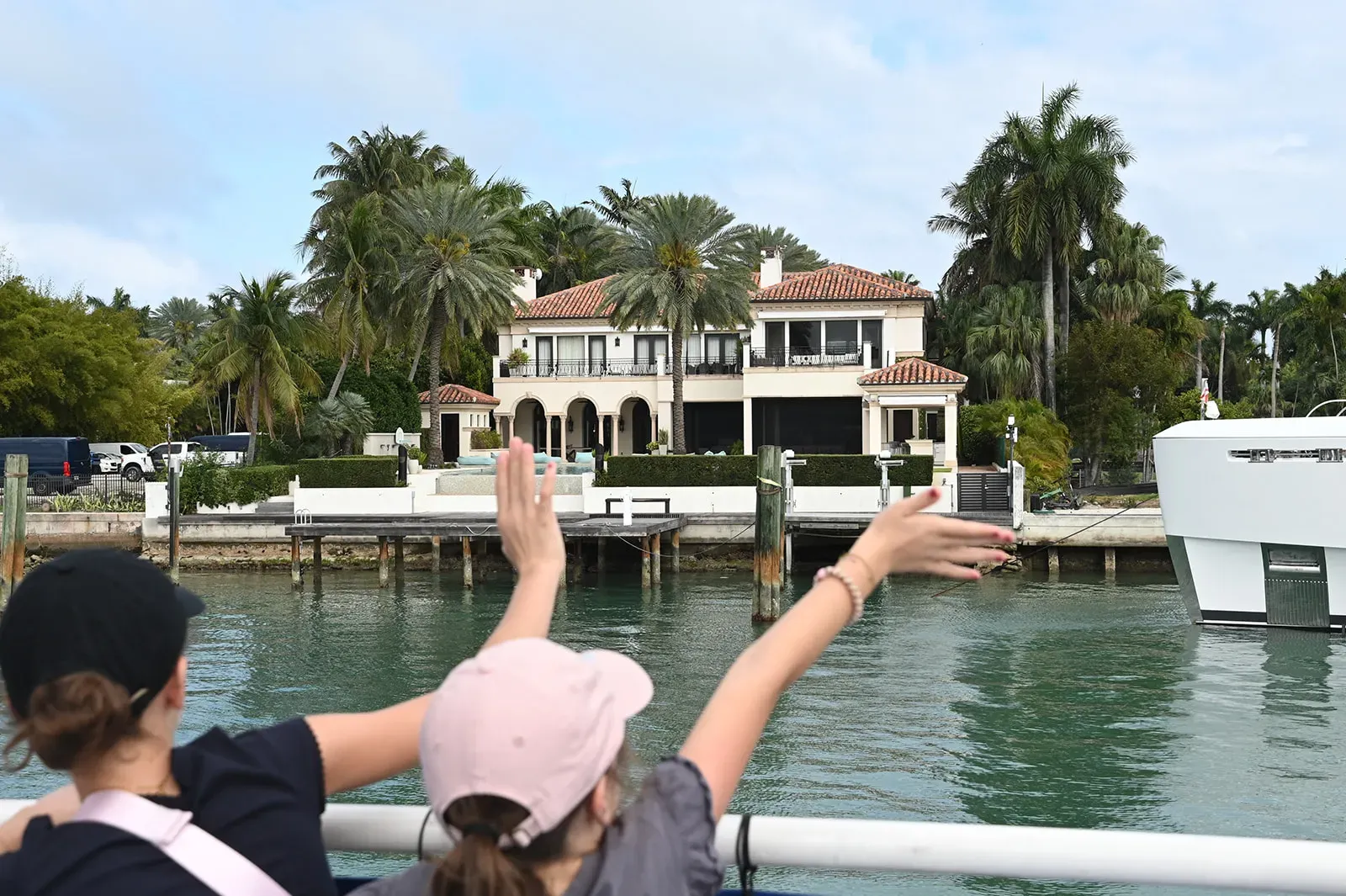 tourists pointing at celebrity homes from a Miami boat tour on Biscayne Bay