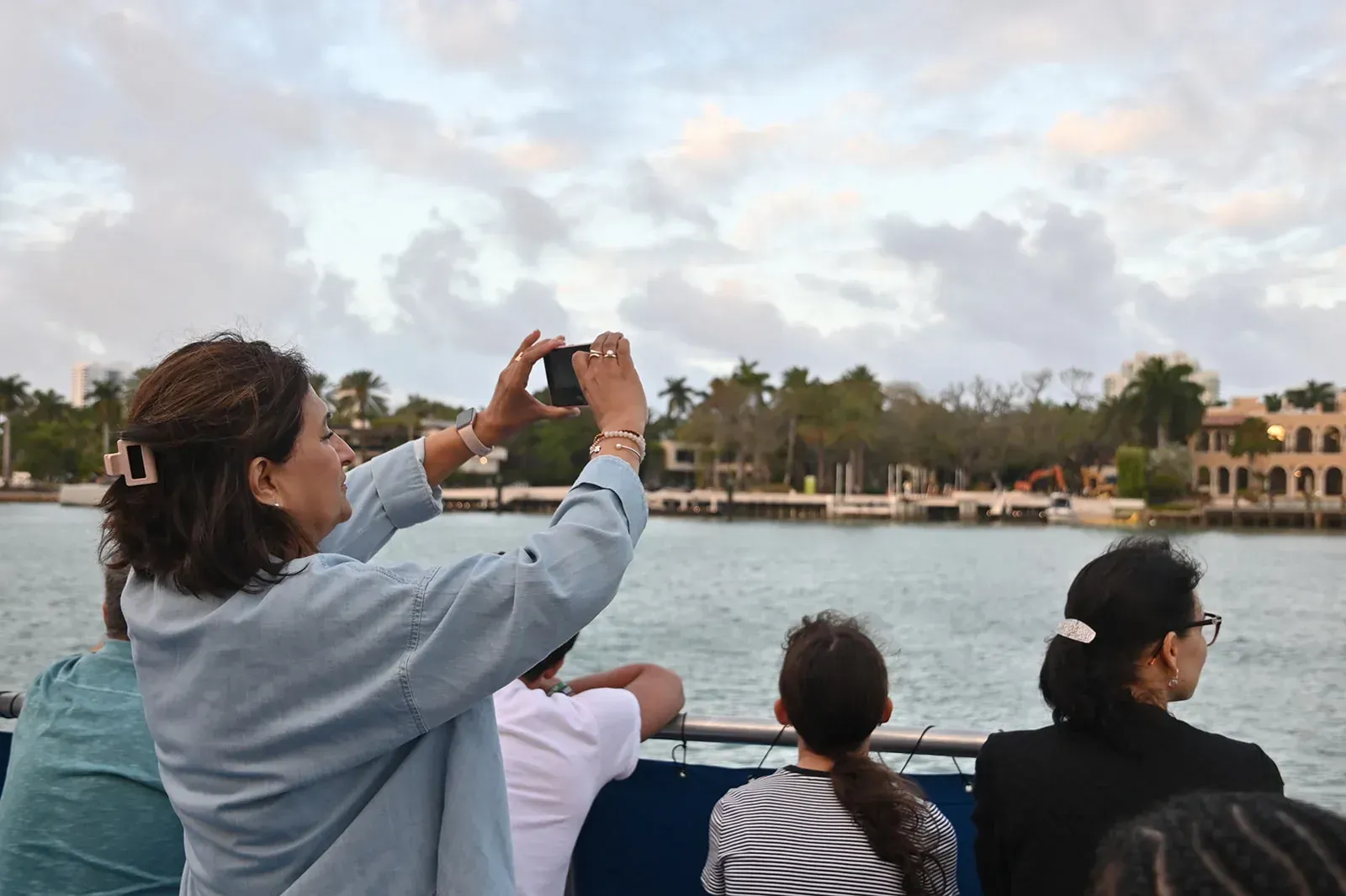 Tourists taking photos of waterfront celebrity mansions on Biscayne Bay in Miami
