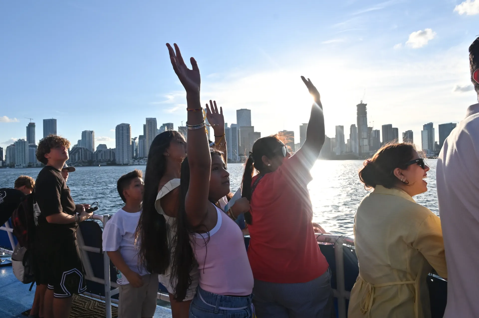 Guests enjoying an interactive sightseeing experience with the Downtown Miami skyline in the background.