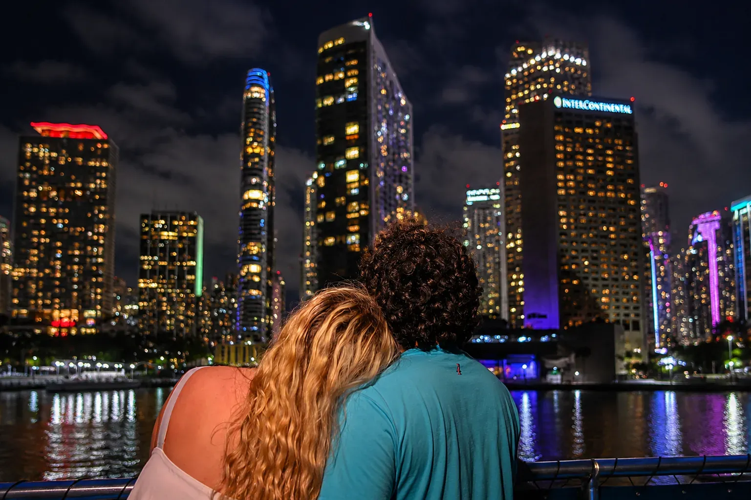 Couple enjoying a Miami Skyline Cruise at night with Downtown Miami skyline views from Biscayne Bay