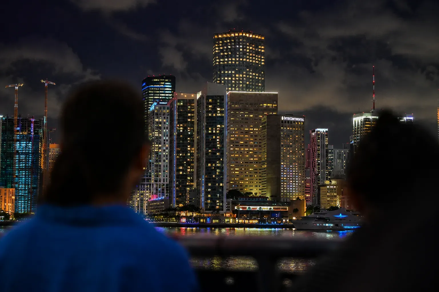 Blurred visitors enjoying the illuminated Miami skyline at night during a skyline cruise in Miami