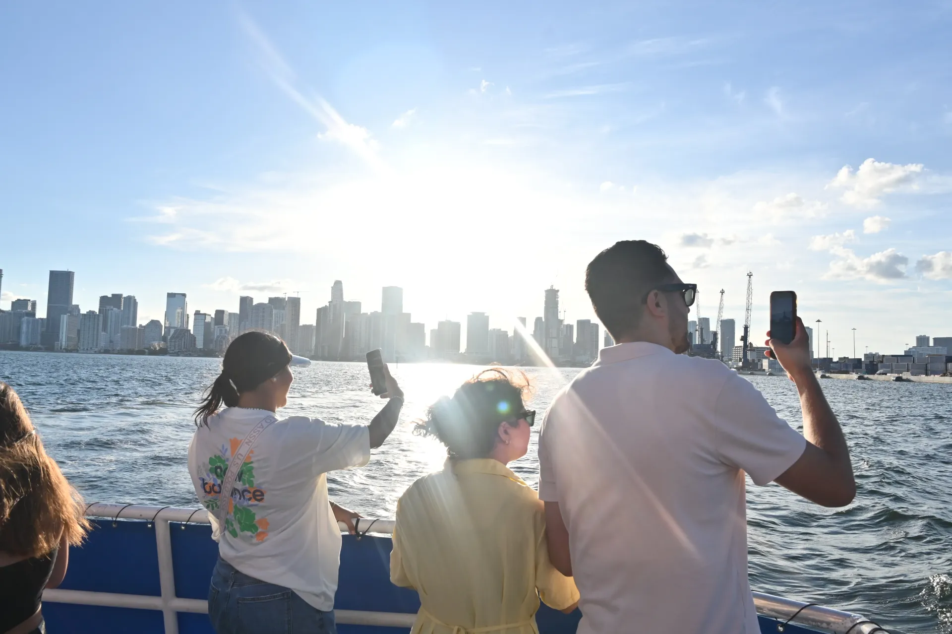 Passengers enjoying panoramic views of the Miami skyline from a sightseeing boat on Biscayne Bay.