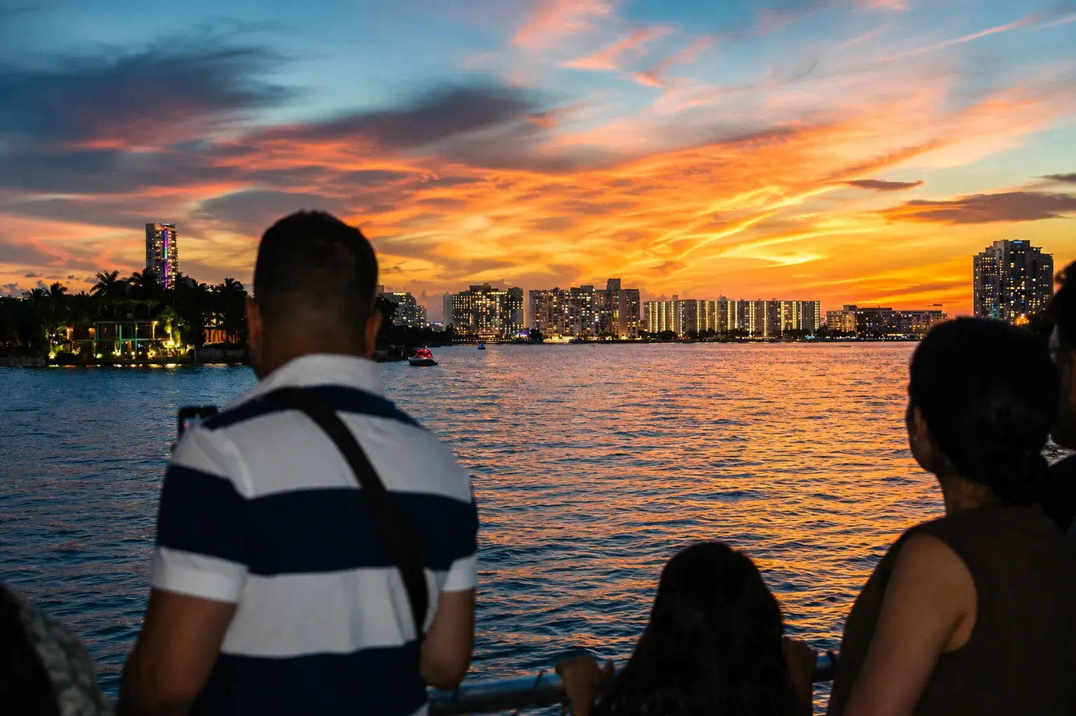 Guests enjoying Miami Sunset Tours with colorful Biscayne Bay sunset reflections and skyline views