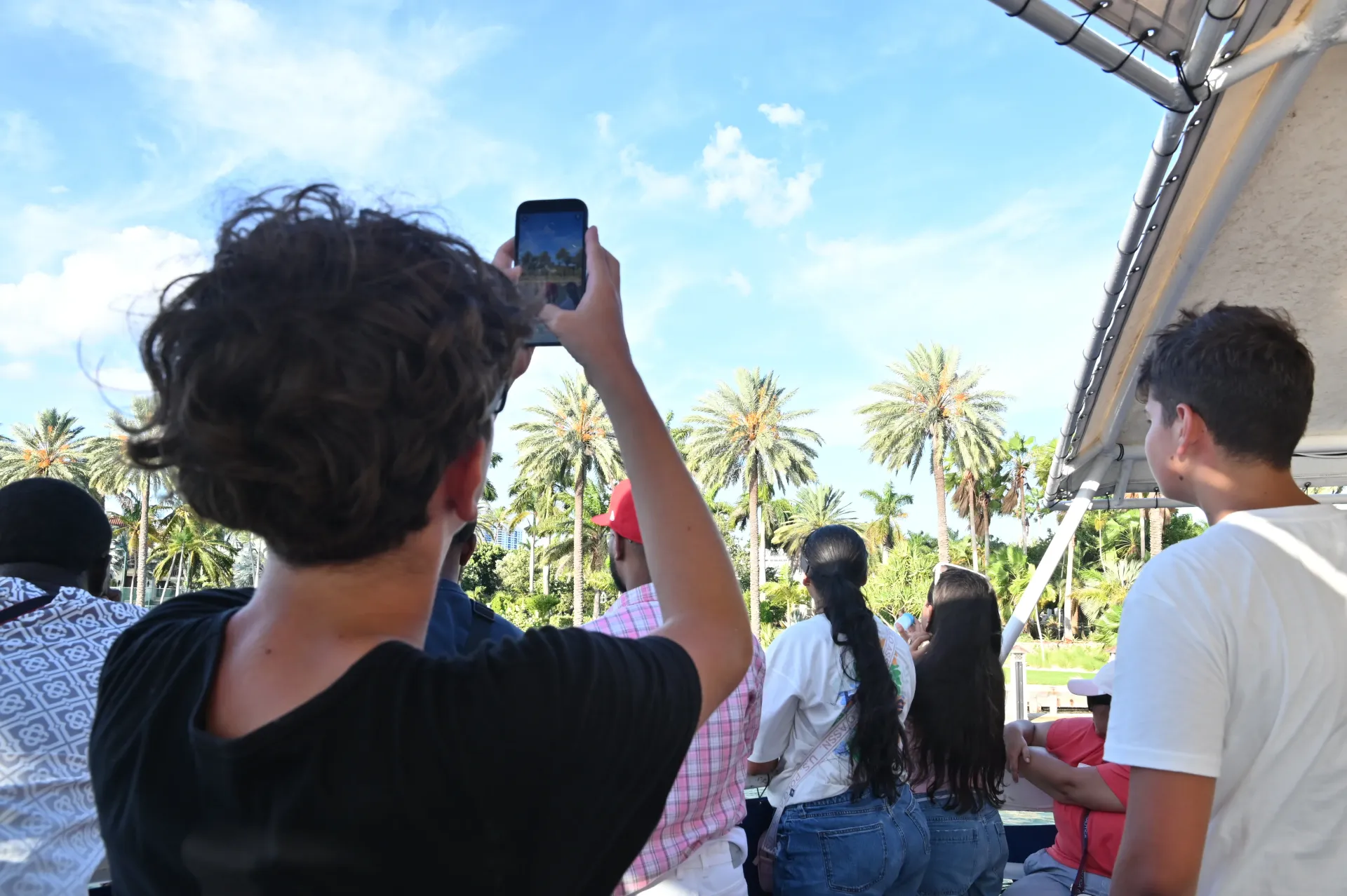 Passenger taking photos during an early morning tour in Biscayne Bay.