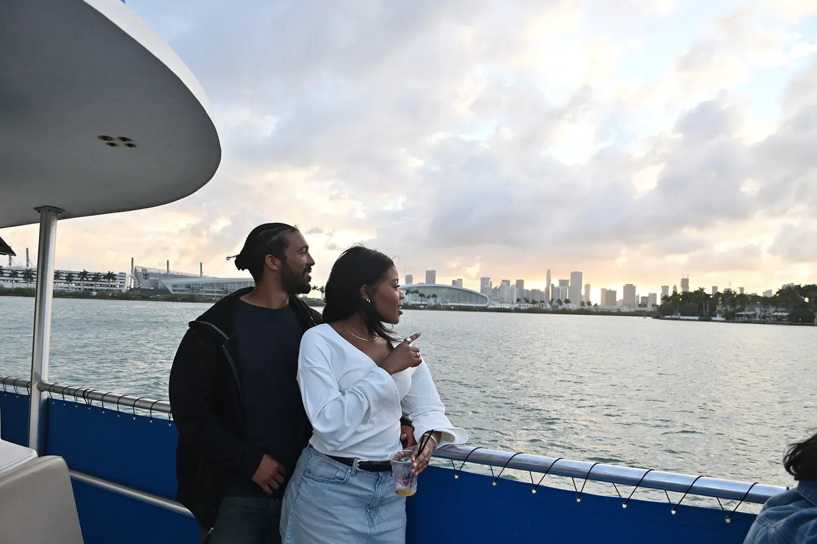 Couple enjoying a sunset Miami boat tour with skyline views on Biscayne Bay