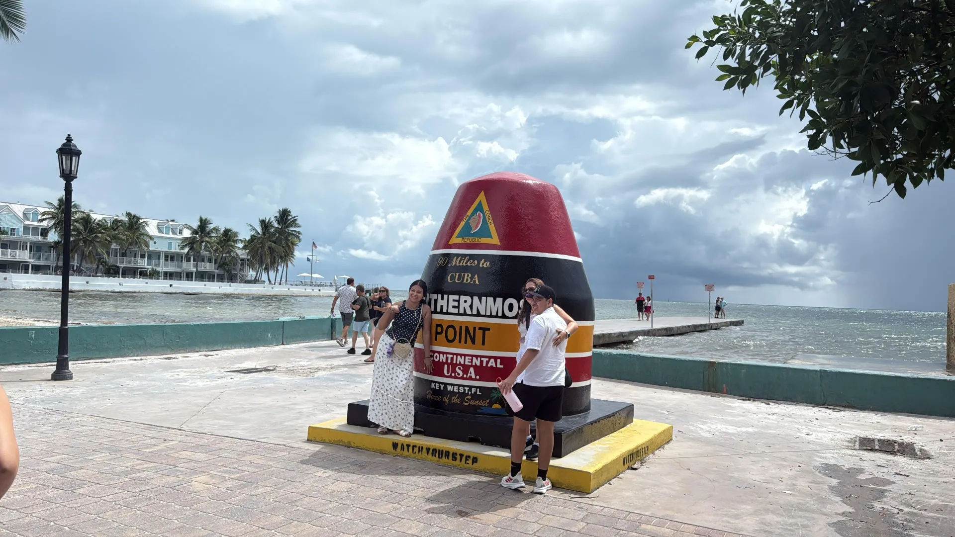 Visitors at the Southernmost Point in Key West during a South Florida staycation.