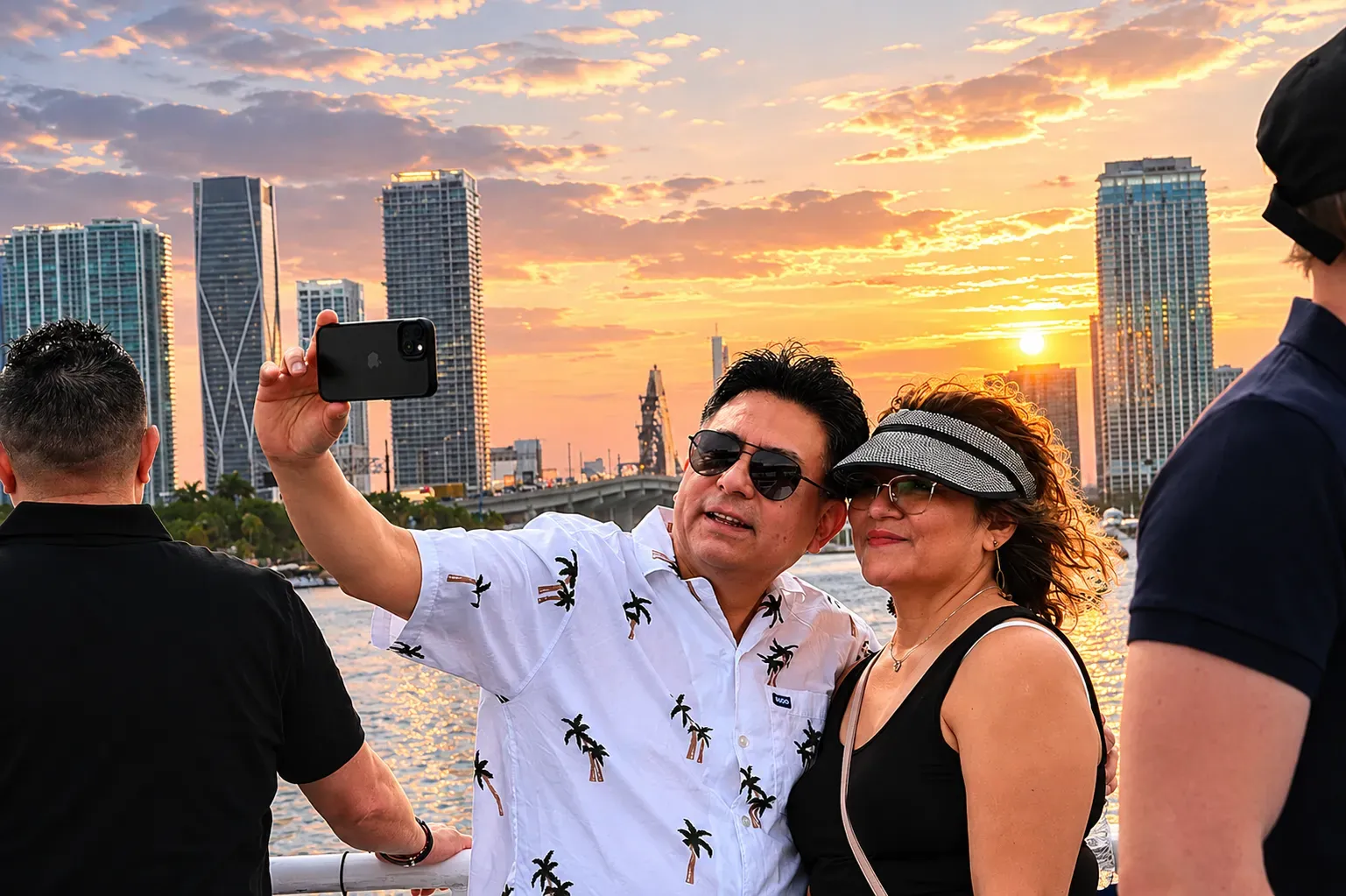 Sunset boat tour from Bayside in Miami with beautiful skyline views, glowing sunset colors, and guests enjoying the cruise on Biscayne Bay.