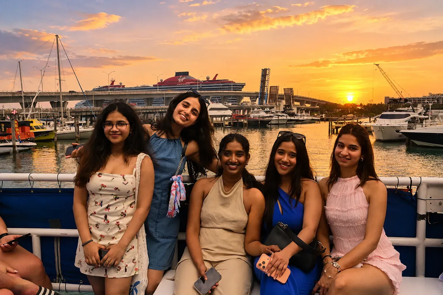 Friends enjoying a sunset tour in Miami on the water in Biscayne Bay with marina and skyline views