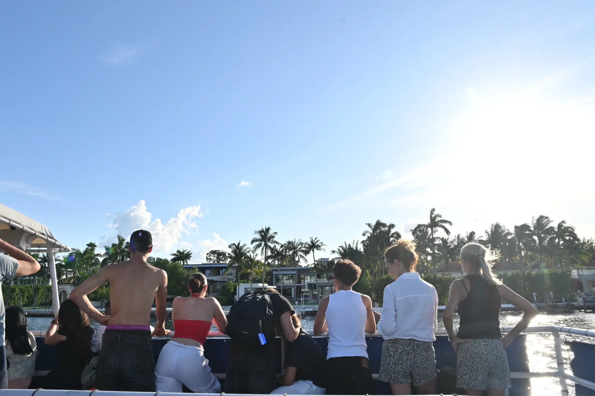 Passengers cruising through the Venetian Islands route on Biscayne Bay, surrounded by luxury waterfront homes and tropical landscapes.