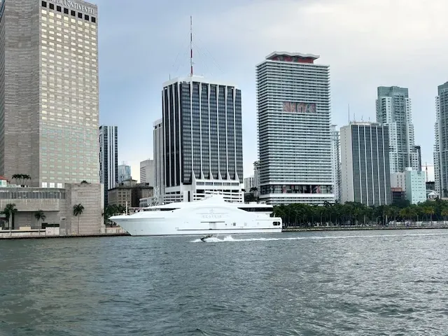 Luxury yacht cruising in front of the Miami skyline