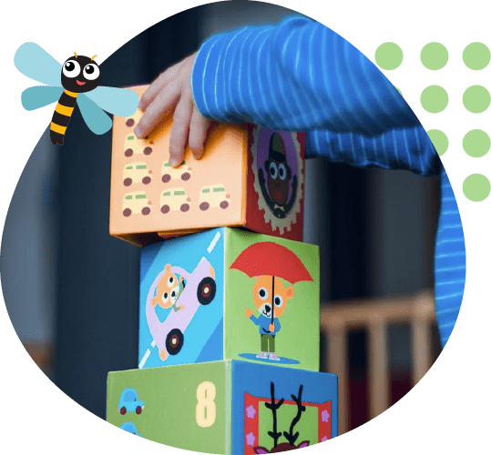 A child stacking blocks with the number 8 on top