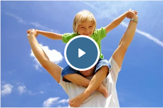 a man is carrying a little boy on his shoulders .