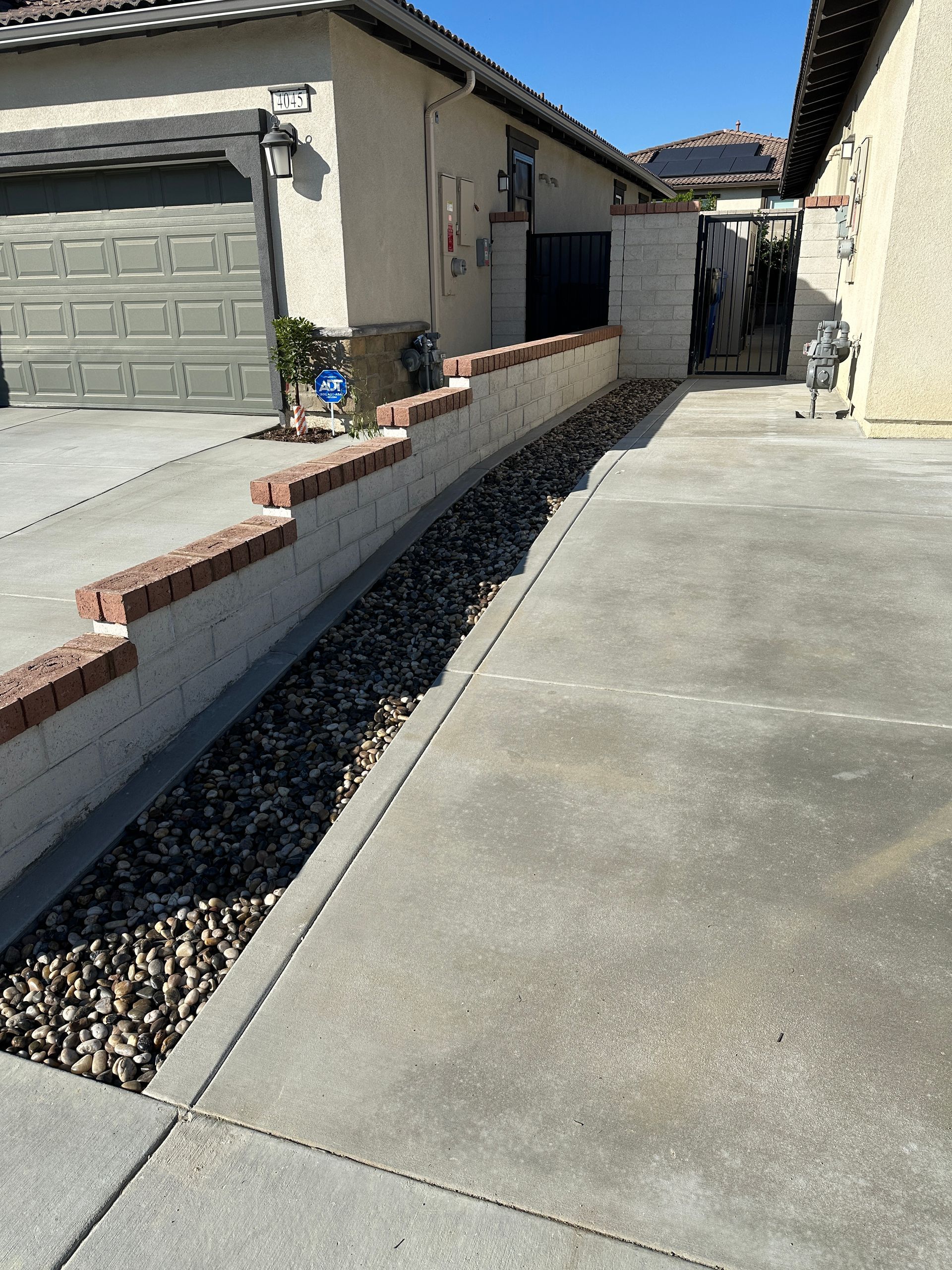 Gloved hands laying stone blocks with mortar during outdoor masonry work
