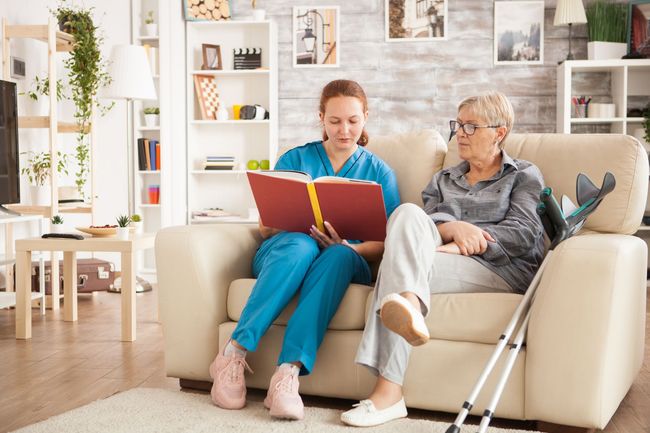 Nurse helping an old man in walking