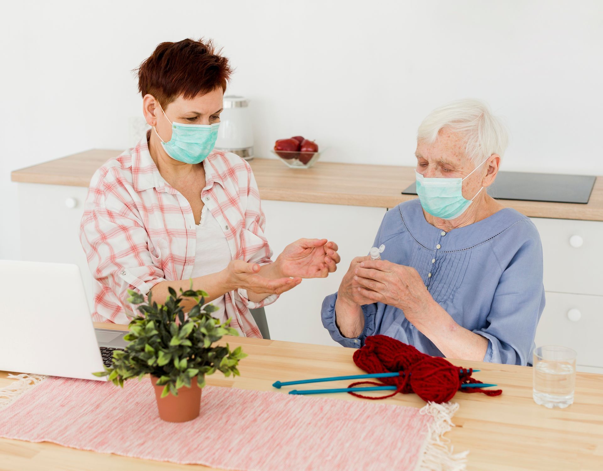Nurse and old woman watching a video together