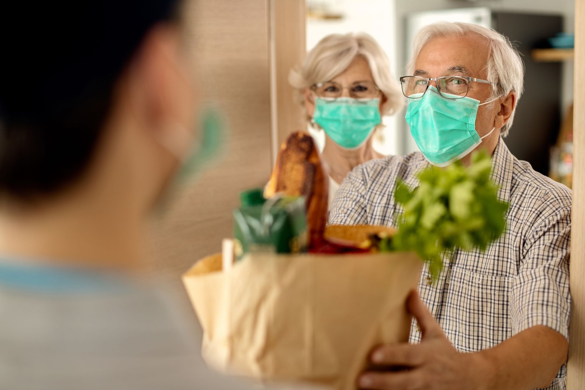 Caretaker bringing groceries for elderly