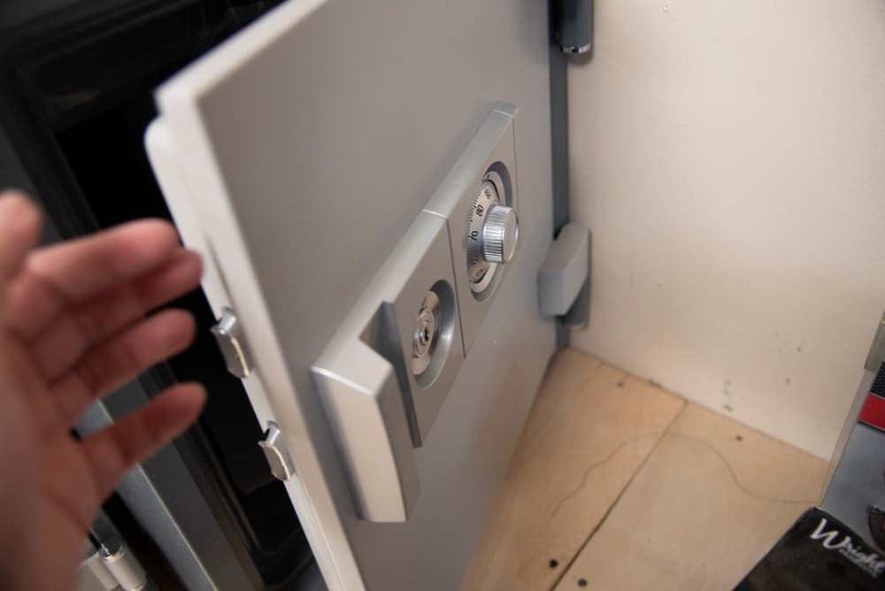 A Person is Opening a Safe With Their Hand — Coast & Hinterland Mobile Locksmiths In Noosaville, QLD