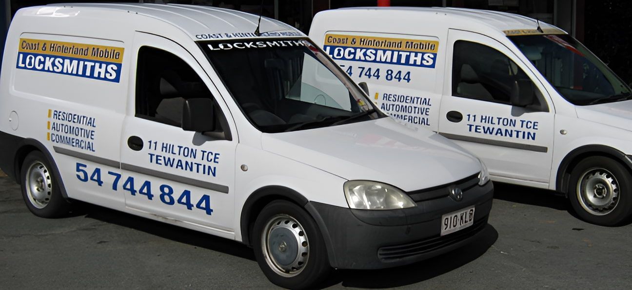 Two White Vans for Locksmiths Are Parked Next to Each Other — Coast & Hinterland Mobile Locksmiths In Noosaville, QLD