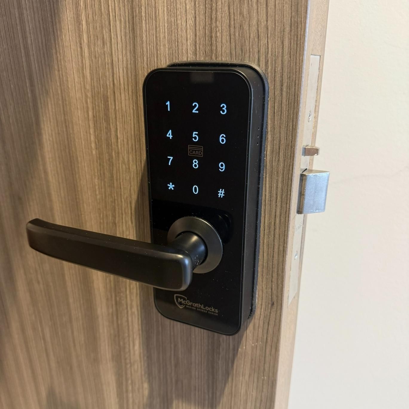 A Close up Of a Digital Door Lock on A Wooden Door — Coast & Hinterland Mobile Locksmiths In Noosaville, QLD