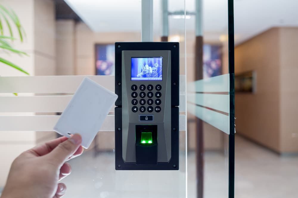 A Person is Holding a Card in Front of a Fingerprint Scanner — Coast & Hinterland Mobile Locksmiths In Noosaville, QLD