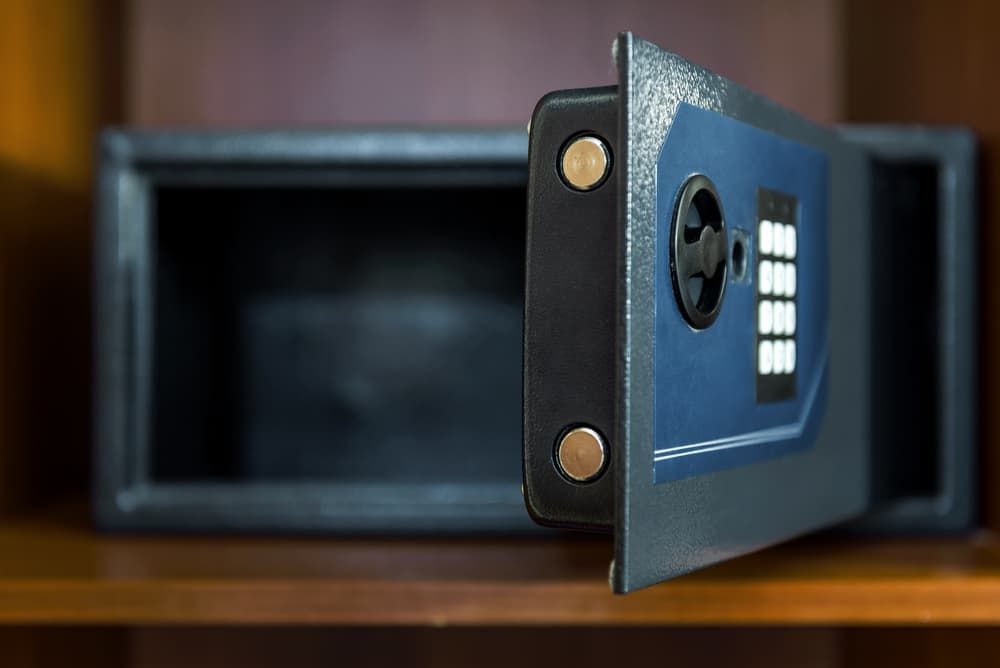 An Open Safe is Sitting on Top of a Wooden Shelf — Coast & Hinterland Mobile Locksmiths In Cooroy, QLD