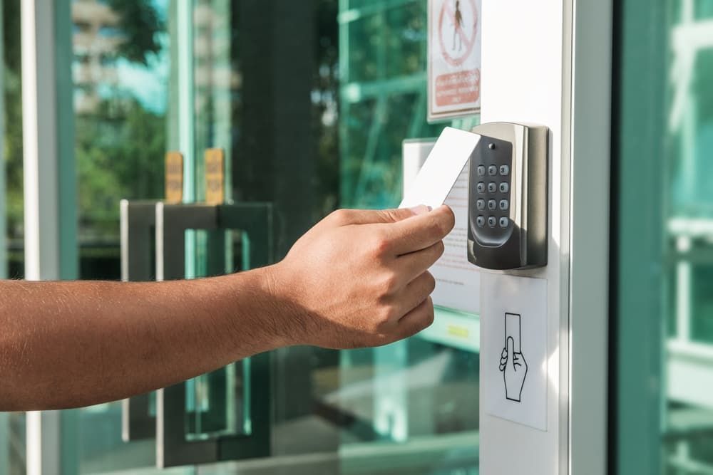 A Person is Using a Key Card to Open a Door — Coast & Hinterland Mobile Locksmiths In Cooroy, QLD