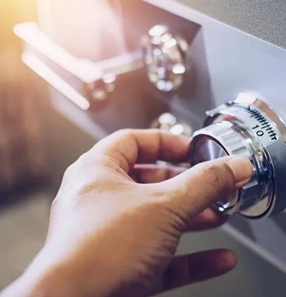 A Person is Opening a Safe With a Combination Lock — Coast & Hinterland Mobile Locksmiths In Peregian, QLD