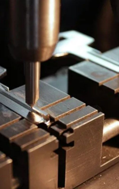 A Machine is Cutting a Piece of Metal in a Factory — Coast & Hinterland Mobile Locksmiths In Noosaville, QLD