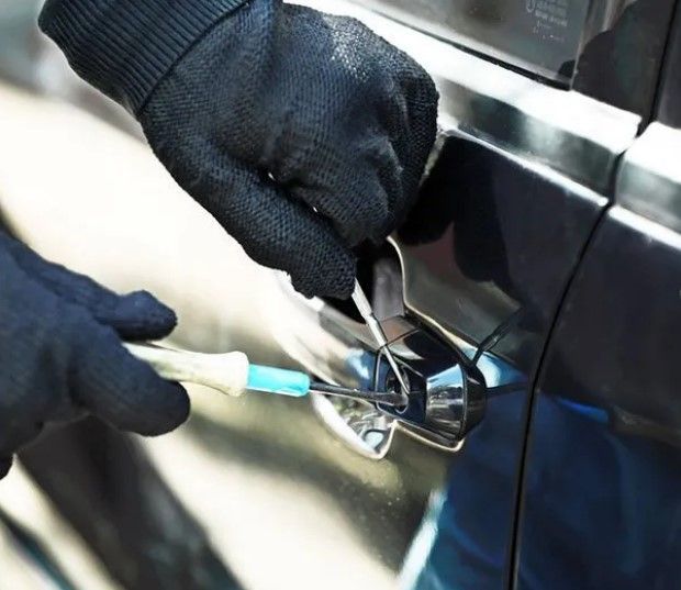 A Person Wearing Black Gloves is Opening the Door of a Car — Coast & Hinterland Mobile Locksmiths In Coolum, QLD