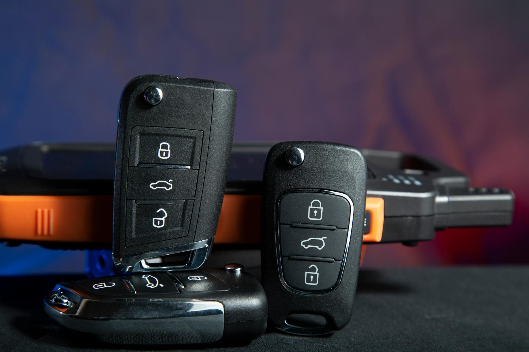 Two Car Keys Are Sitting Next to Each Other on A Table — Coast & Hinterland Mobile Locksmiths In Noosaville, QLD