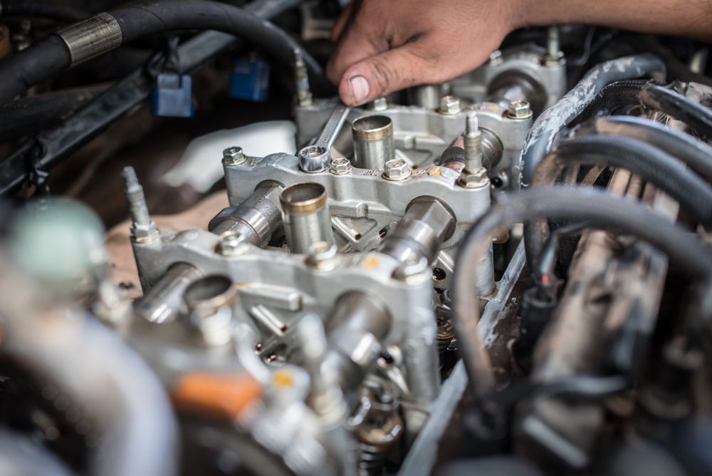Hand Using Wrench on Car Engine — CE Automotive Service Centre in Garbutt, QLD
