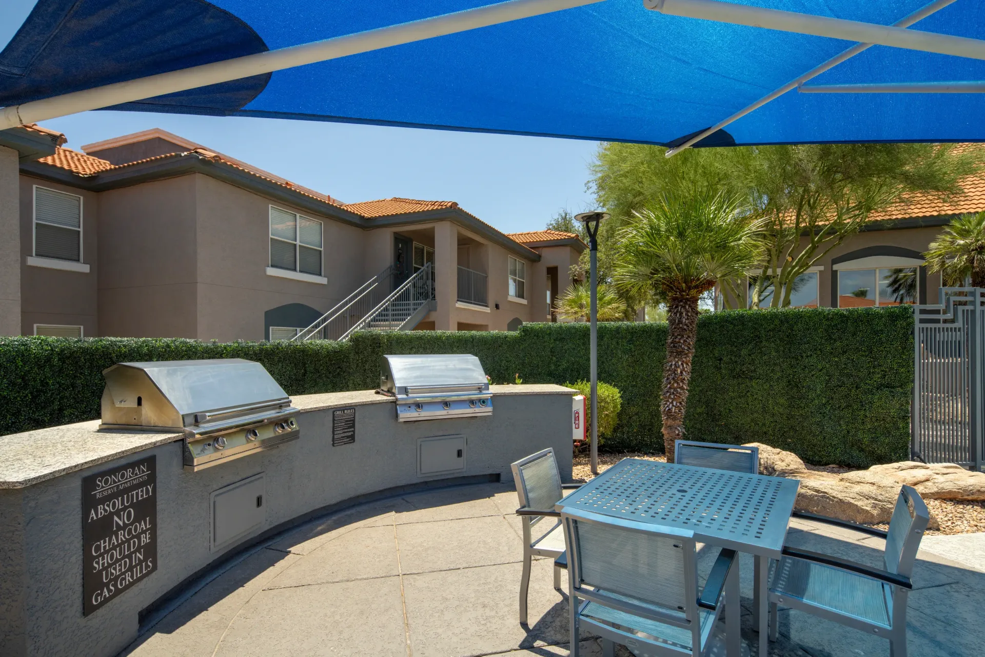 Outdoor grilling area with stainless steel grills and seating at Sonoran Reserve in Tucson, AZ.