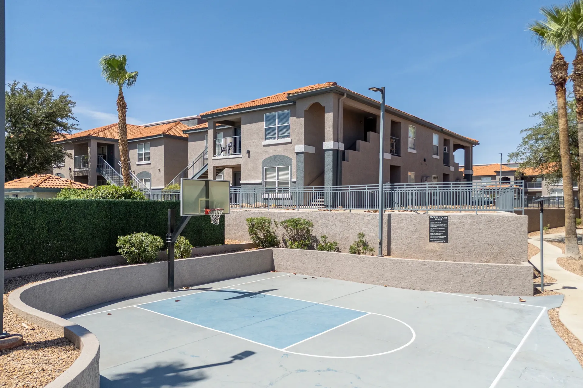 Outdoor basketball court with apartment buildings in the background at Sonoran Reserve in Tucson, AZ.