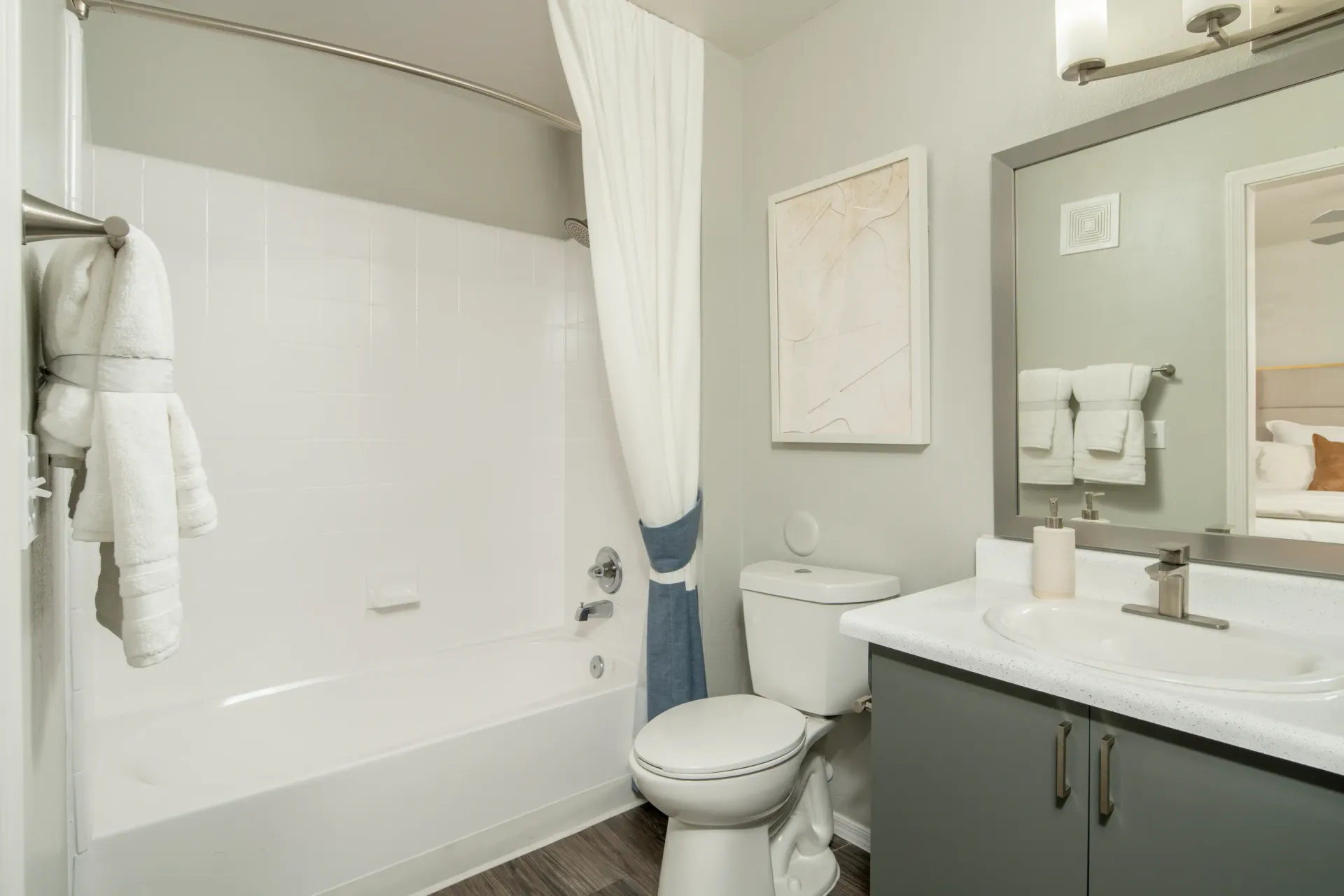 Modern bathroom with a bathtub, toilet, and vanity with sink at Sonoran Reserve in Tucson, AZ.